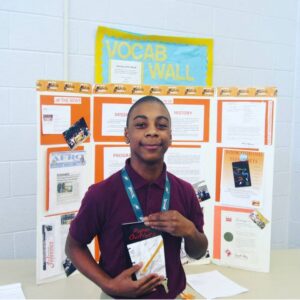 A young man holding an ipod in his hands.