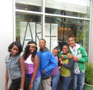 A group of people standing in front of a building.