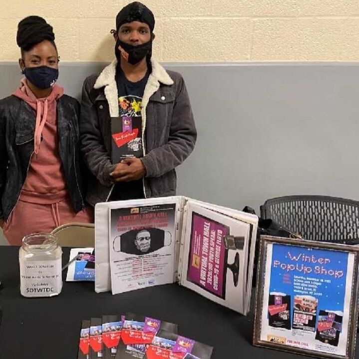 Dathan Fenwick, student co-host with Michelle Tillery, book signing copies of Dear Black People